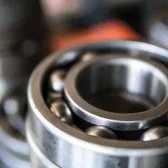 Zbliżenie na metalowe łożysko kulkowe z widocznymi kulkami.