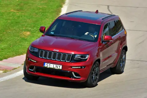 Czerwony Jeep Grand Cherokee na torze. Na tablicy rejestracyjnej widnieje napis S1 LNY. Ile liter ma własna rejestracja?